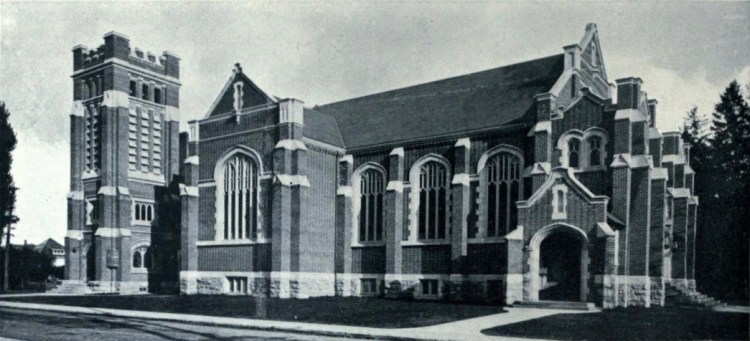 Black and white photo of St. Giles church in Hamilton, Ontario. The photo shows its west elevation in 1916, shortly after its construction. It is a neo-gothic brick chuch, with detailed tracery, a square tower, and beautiful windows.
