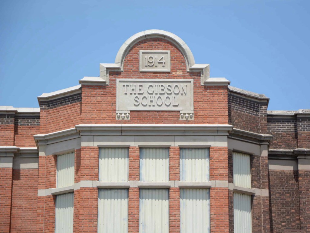 Central parapet of the Gibson School with datestone and school name